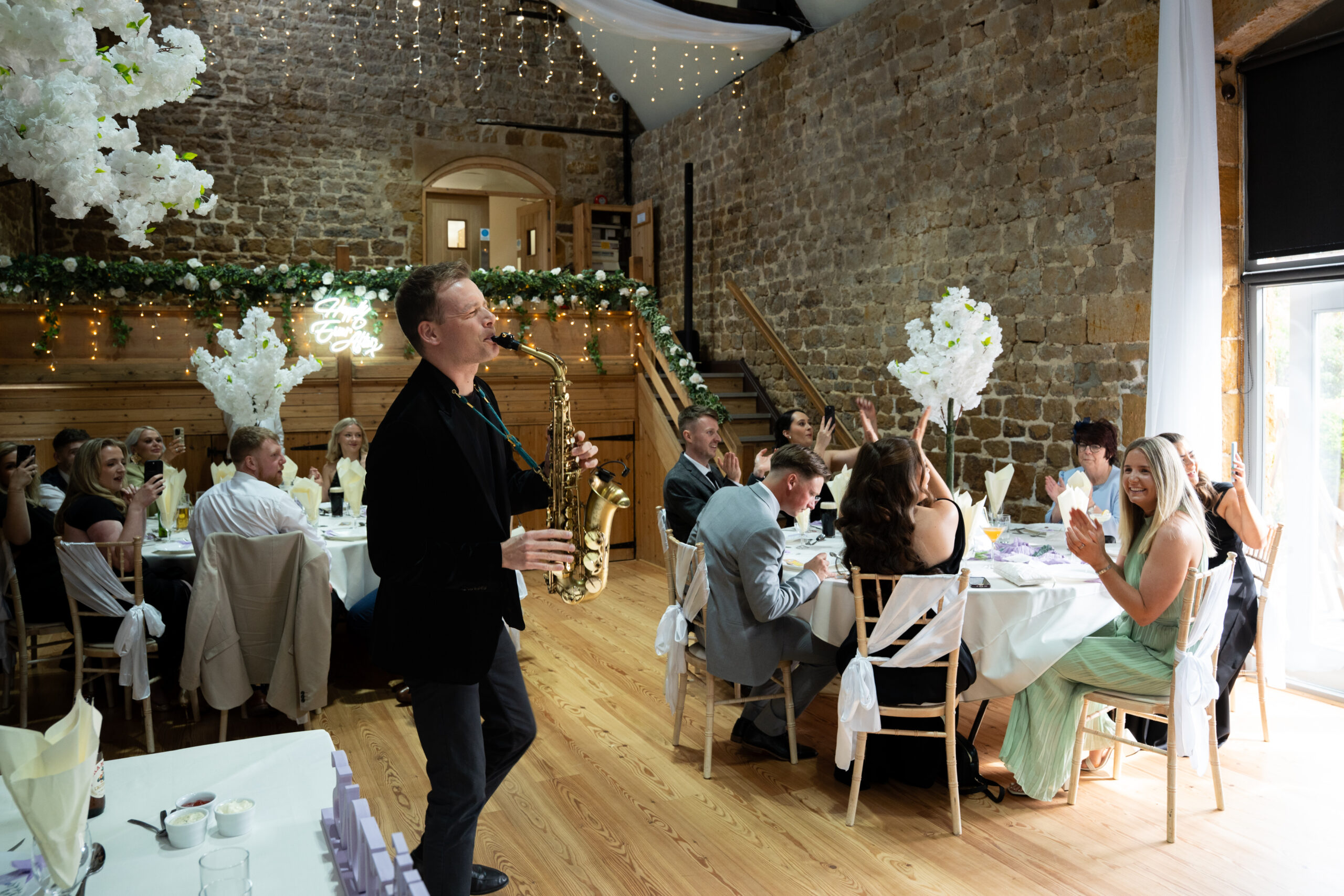 saxophonist at a magical barn wedding